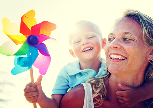 woman and child smiling and playing together