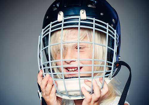 child wearing a helmet while smiling