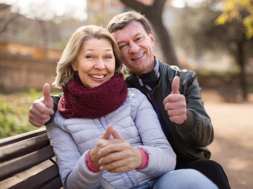 elderly couple in the park happy and smiling